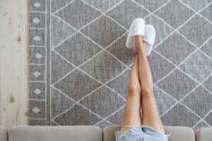 woman sitting couch with her feet carpet