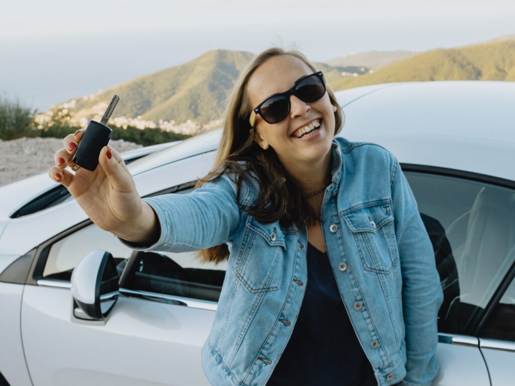 Smiling Woman Showing new Rental car keys