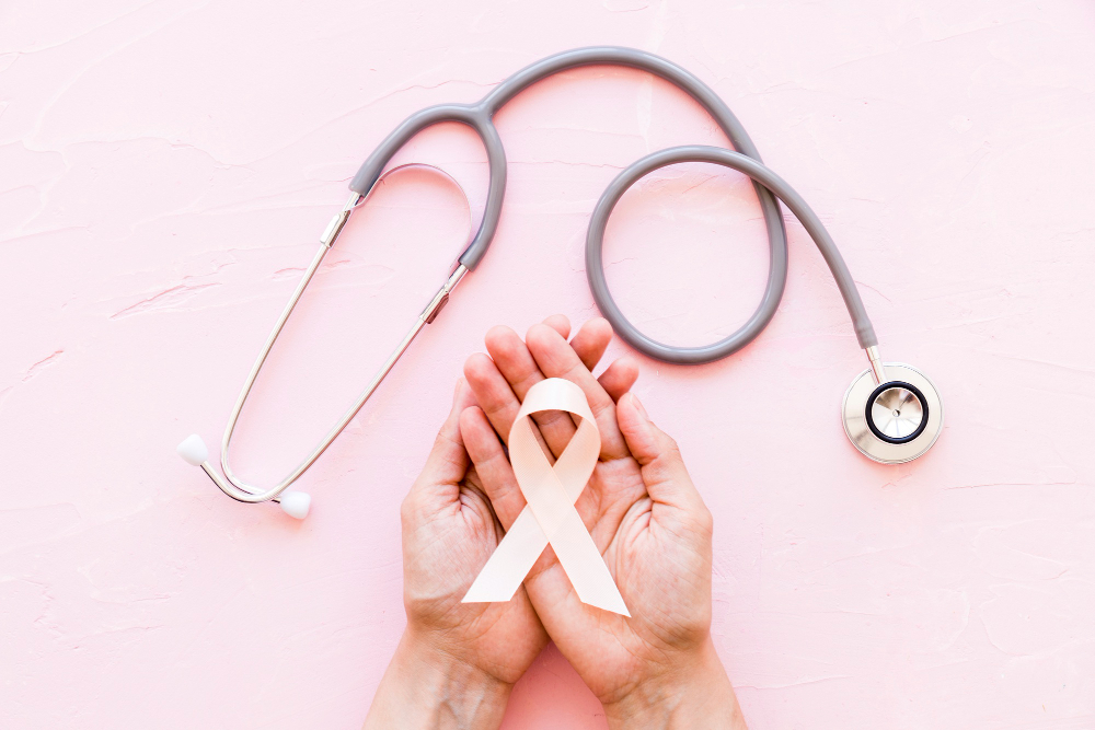 white awareness ribbon two hands with stethoscope pink background